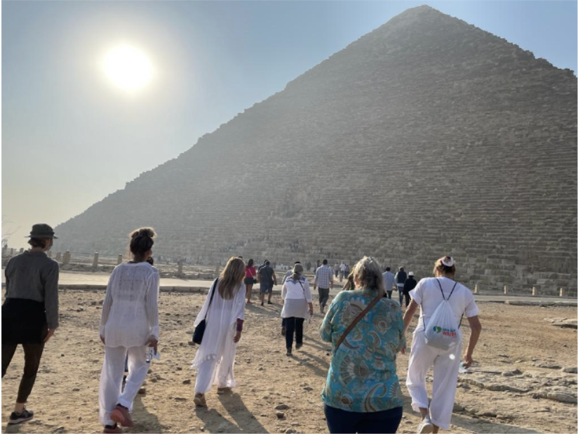Group walking toward pyramid exterior