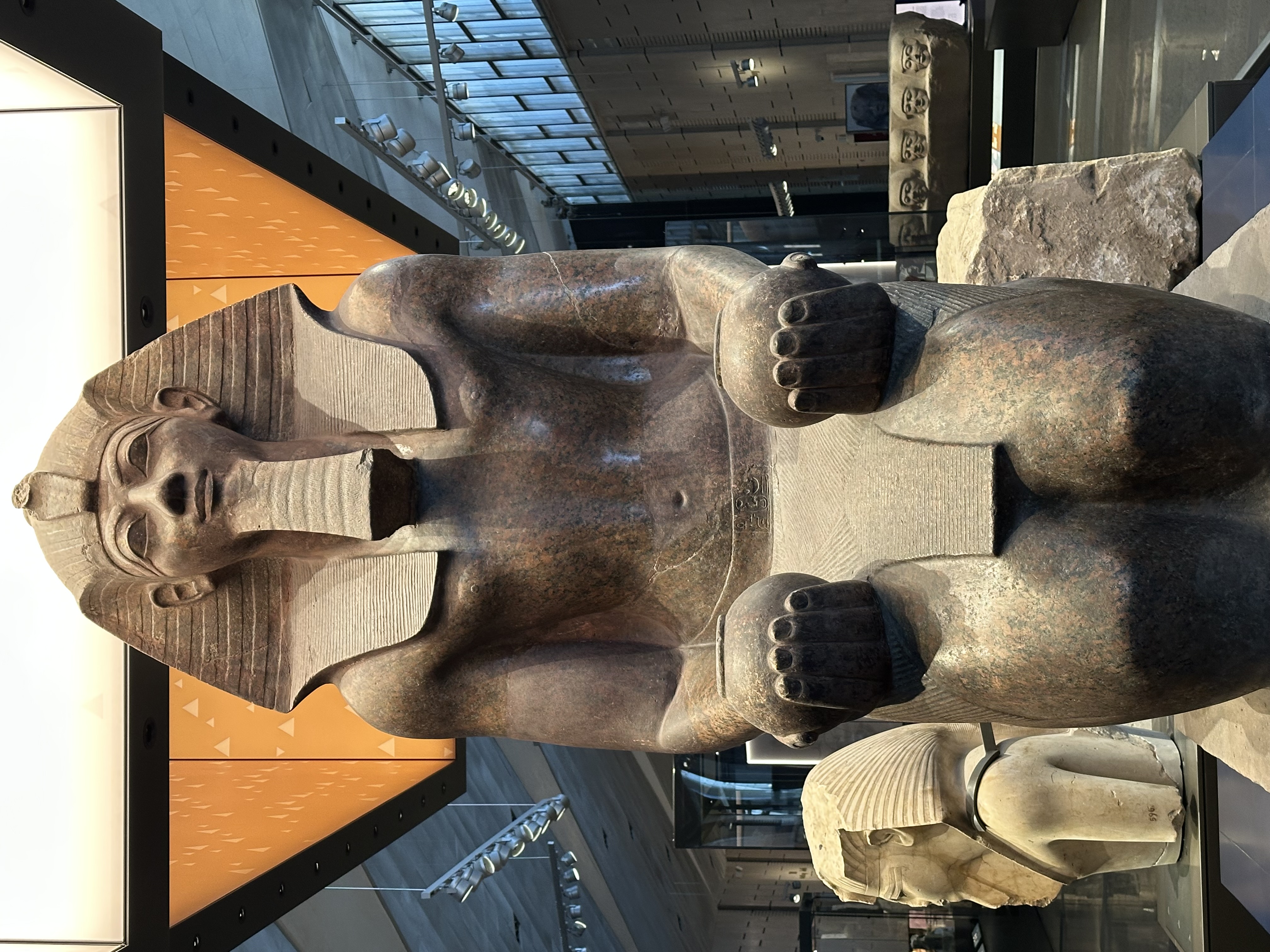 Massive seated pharaoh statue in museum