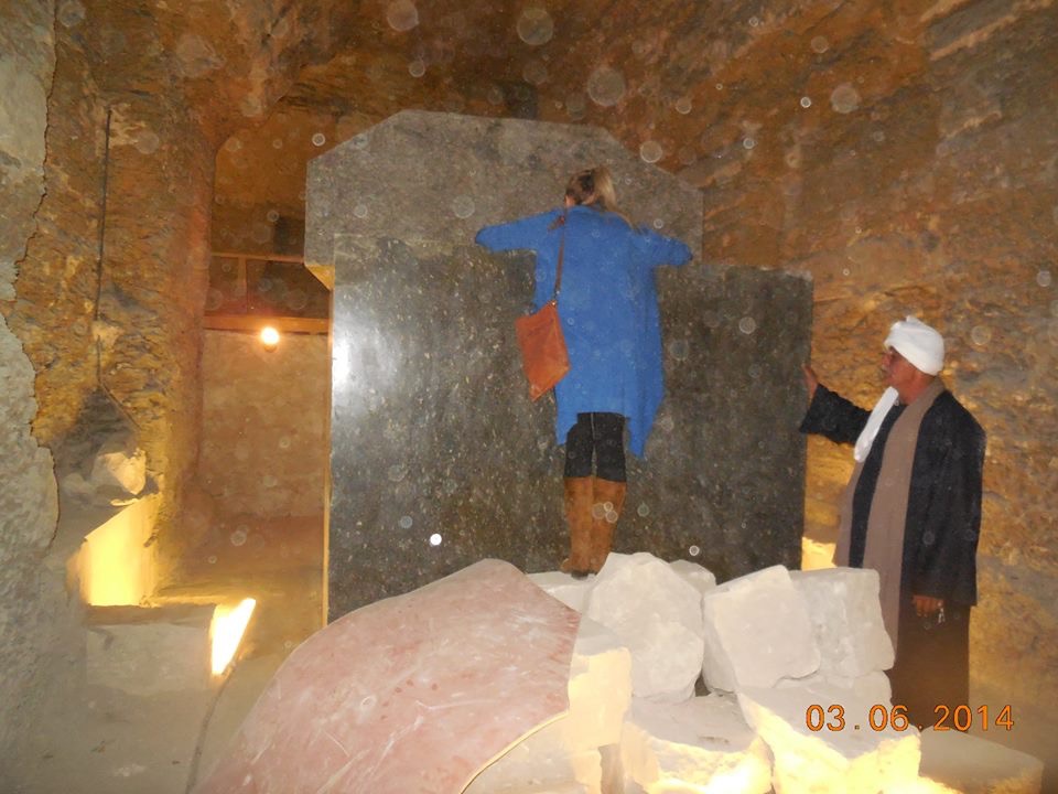 Person examining stone box