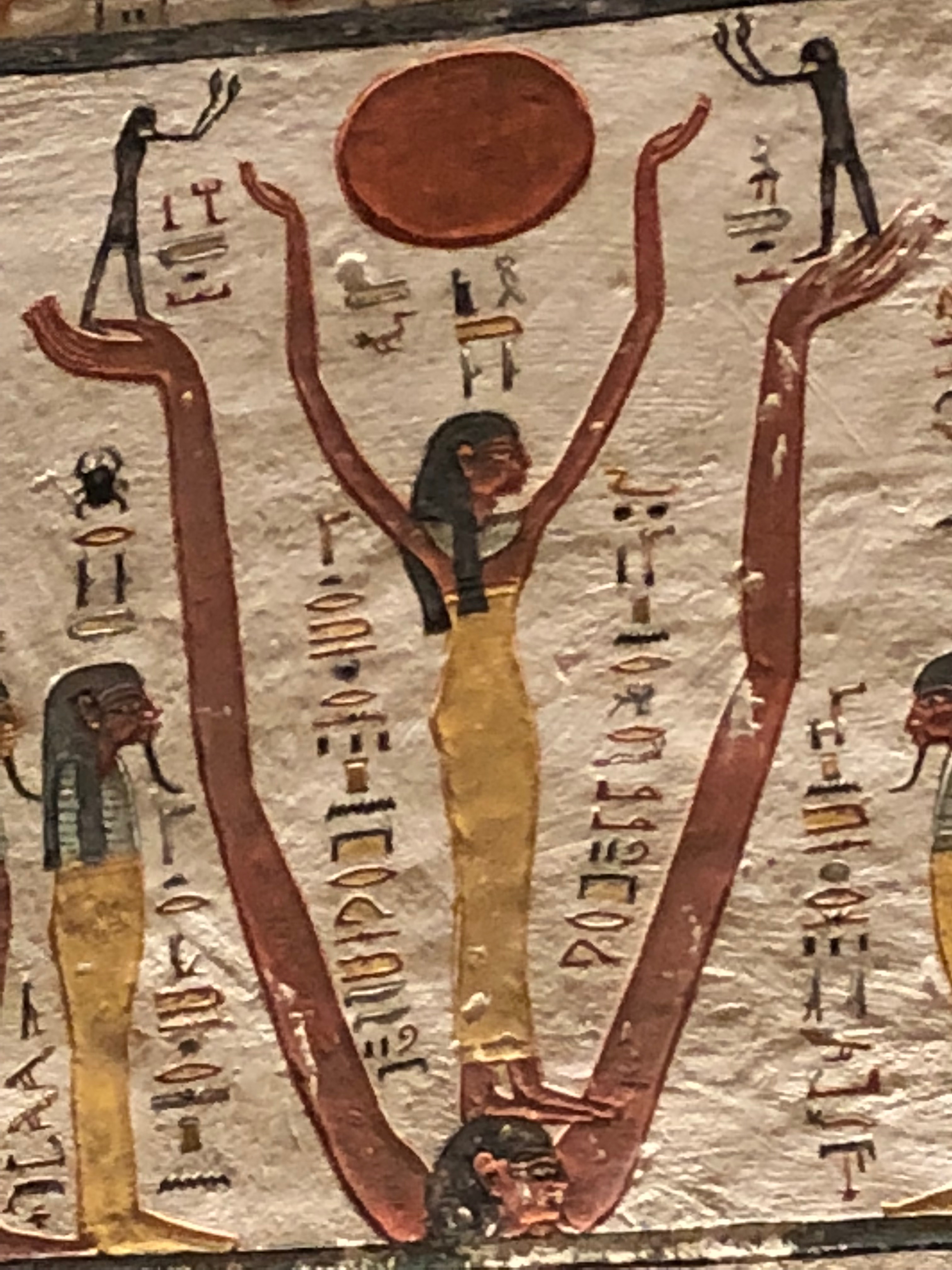 Painted figure holding sun disk